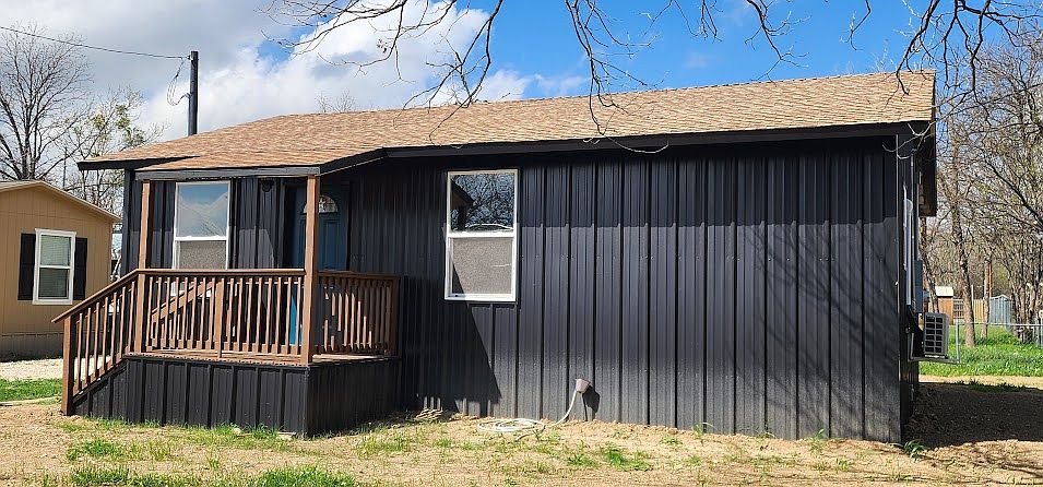 Front view of this bold, eye-catching new home with its spacious covered front deck