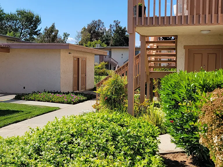 Beautiful landscaping outside apartment units at Plaza Verde Apartments in Escondido, California.