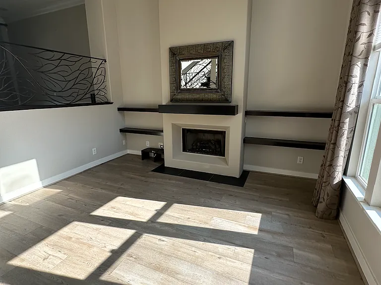 Living room with 18' ceiling and gas fireplace.