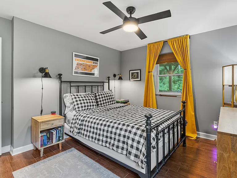 Bedroom #2 with a Queen bed, room-darkening shades, ceiling fan, and a dresser.