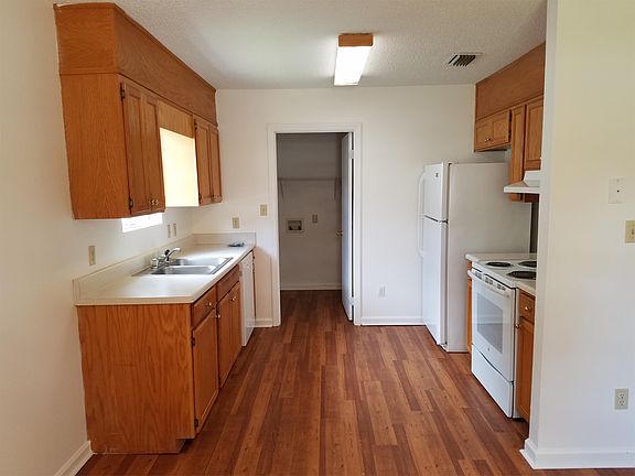 Kitchen with new appliances and laundry room / mud room.