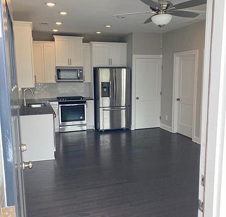 Full kitchen and living space at the entrance, which includes a closet with a washer and dryer.