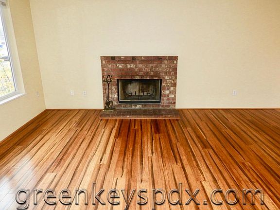Tiger wood floors and wood-burning fireplace