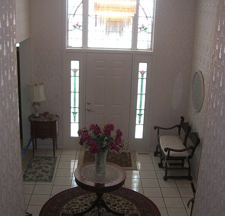 Foyer
						:
						Ceramic Tile Floor and Custom-Made Stained Glass Windows at Entry Way.