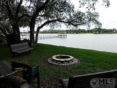 Benchs and fire pit next to dock and ramp. Dock in photo belongs to neighboring property owner.