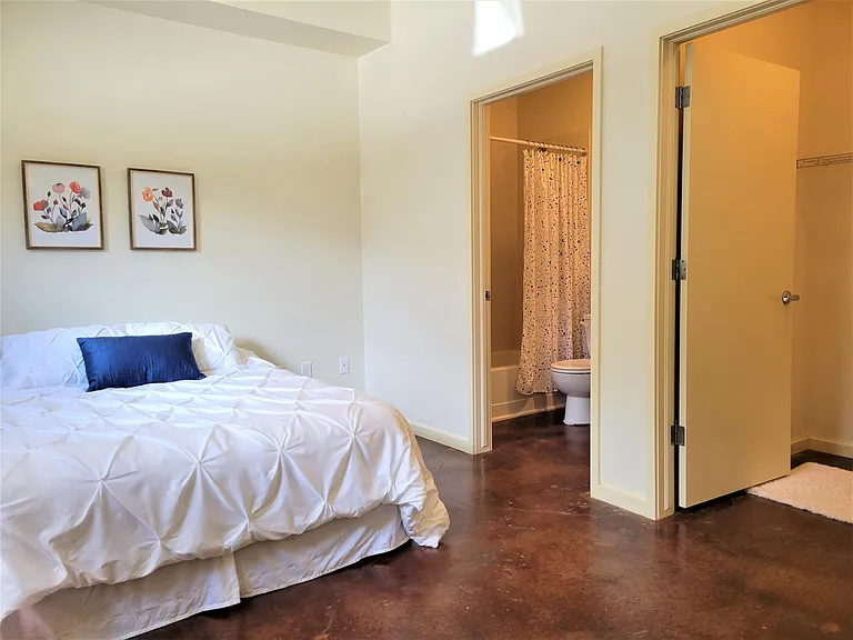 Primary bedroom with bathroom and walk in closet