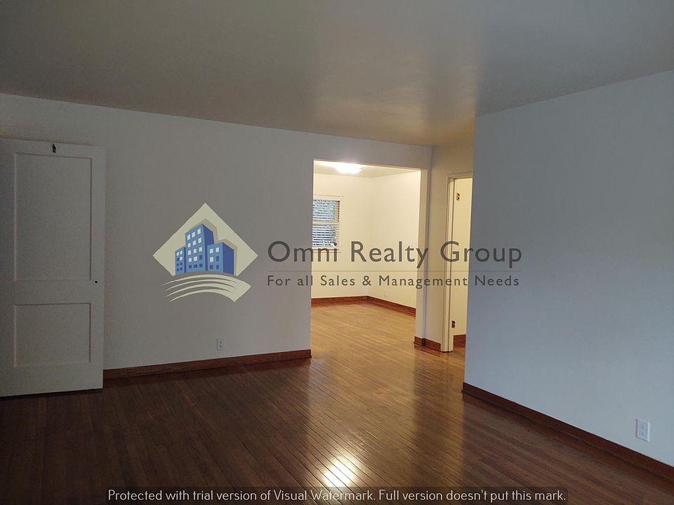 Living room looking into dining space and hall entry