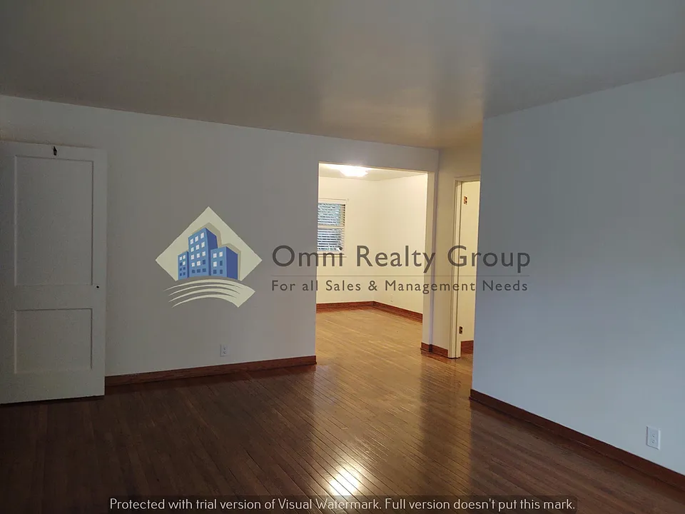Living room looking into dining space and hall entry