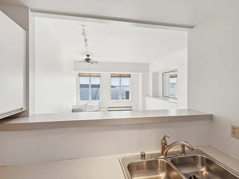 View from Kitchen towards living room and windows.
