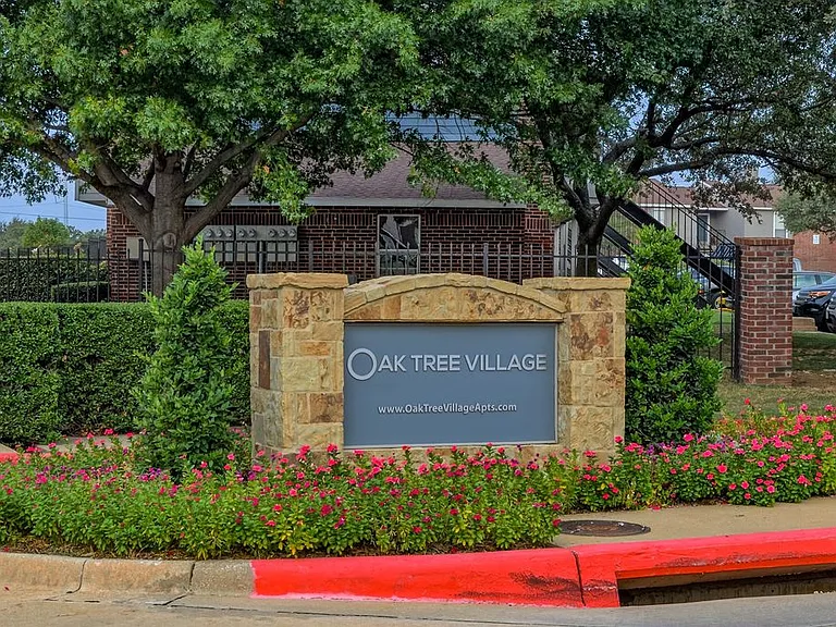 Oak Tree Village Apartments Exterior Front of Building and Sign