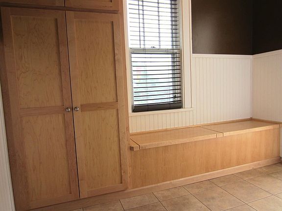 Rear entryway has extra storage with custom maple cabinets.