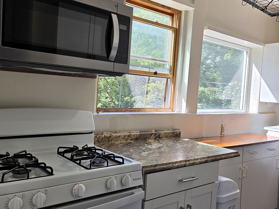 Bright kitchen with natural light showing over the range microwave, gas stove