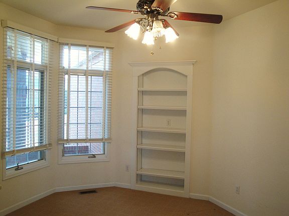 Built-in shelving and bay window in study