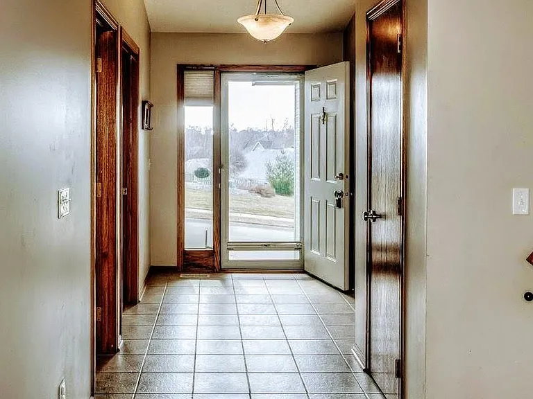 Front entry. Second bedroom & bath on the left, guest closet and stairs to lower level on right, living room straight ahead.