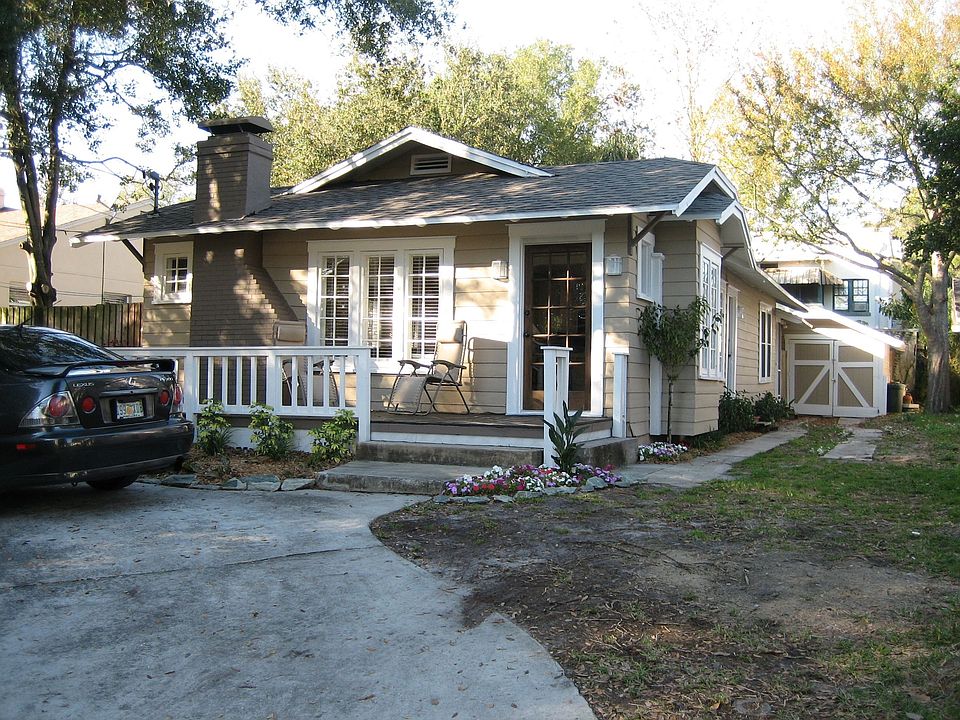 Circular drive and small detached garage/shed in back.