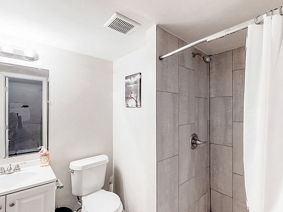 Shared lower level full bathroom with standing shower.