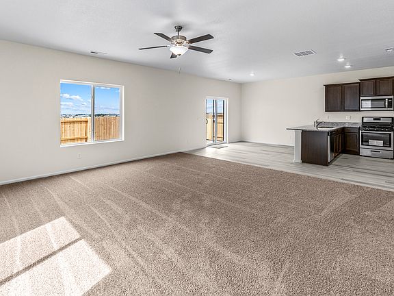 Open-concept layout with a spacious living room, breakfast area, and chef-ready kitchen.