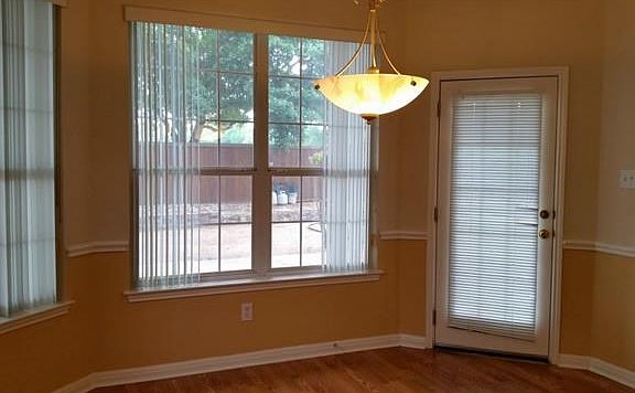 Breakfast area with crown molding and chair rail; opens to back patio and kitchen as well as living room
