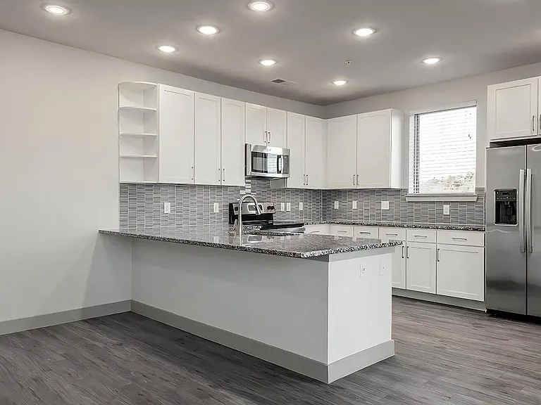 Modern Kitchen with Oversized Granite Breakfast Bar and Ample Storage