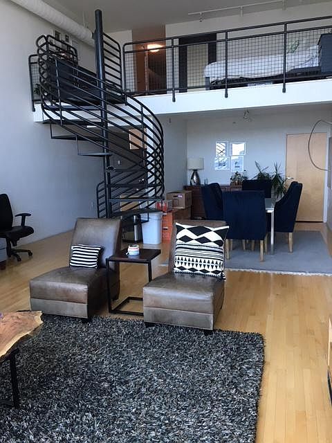 living room, dining room, lofted master bedroom and kitchen (behind spiral staircase)