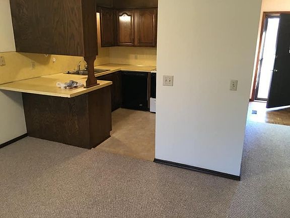 View of kitchen & front door from living room