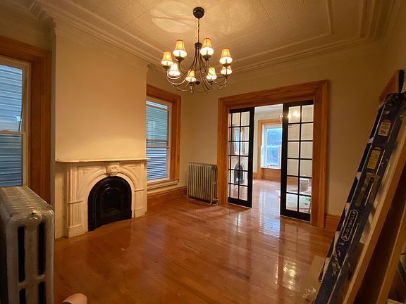 Double parlor with marble fireplaces and pocket doors. There is a bit of work just wrapping up in the apartment before it is ready on August 15.