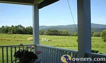 Morning coffee or tranquil evening views from wraparound porch.