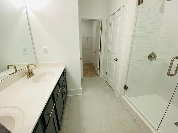 Master Bath with double vanity counter, walk-in shower and closet
