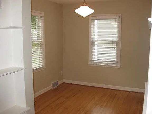 Dining room with hardwood floor and plantation shutters