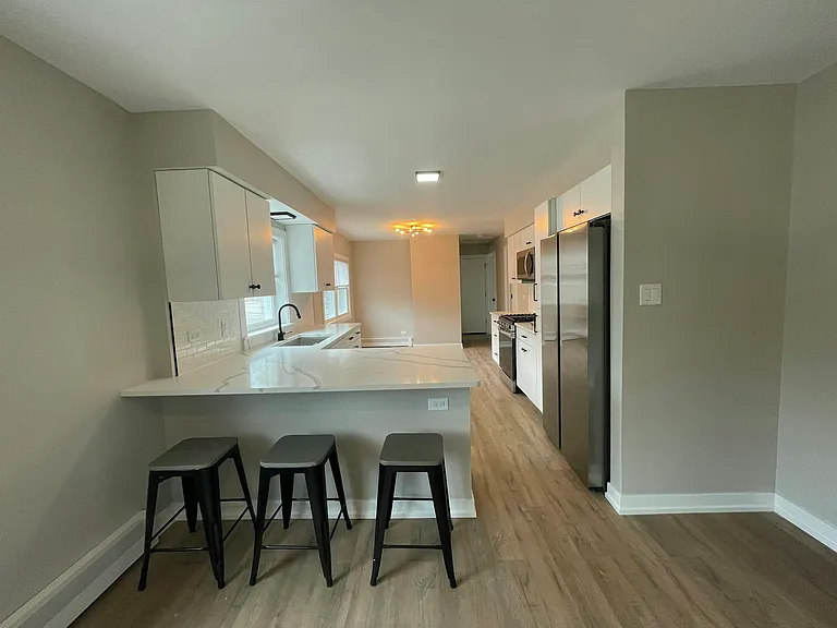 luxury kitchen with quartz countertops and stainless steel appliances