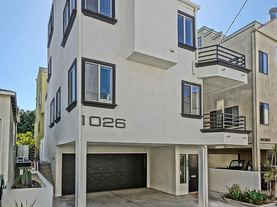 Front of house, two car garage and two parking spaces in the driveway