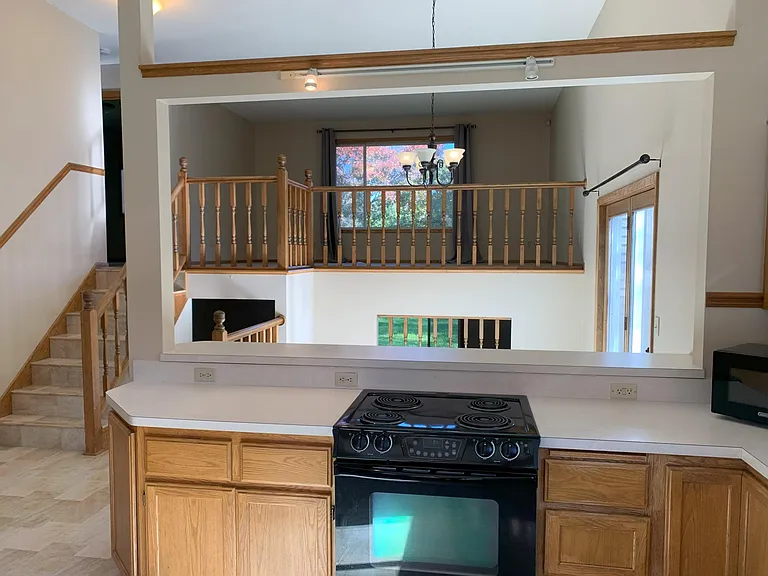 View from kitchen to the dining room and living room. Vaulted and open floor plan.