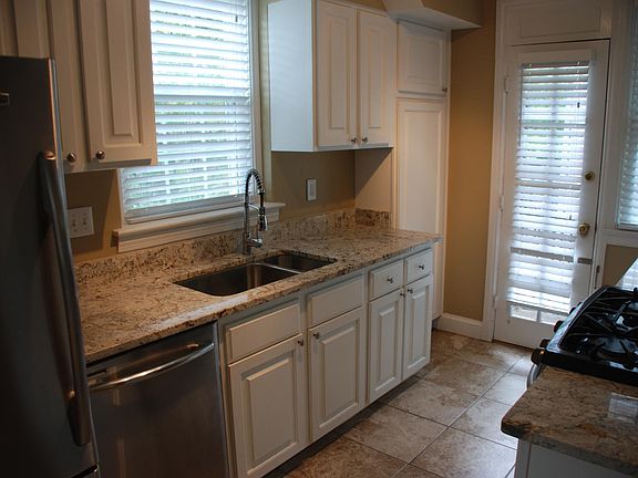 Kitchen with stainless steel appliances, granite counter tops, as stove & ceramic floors