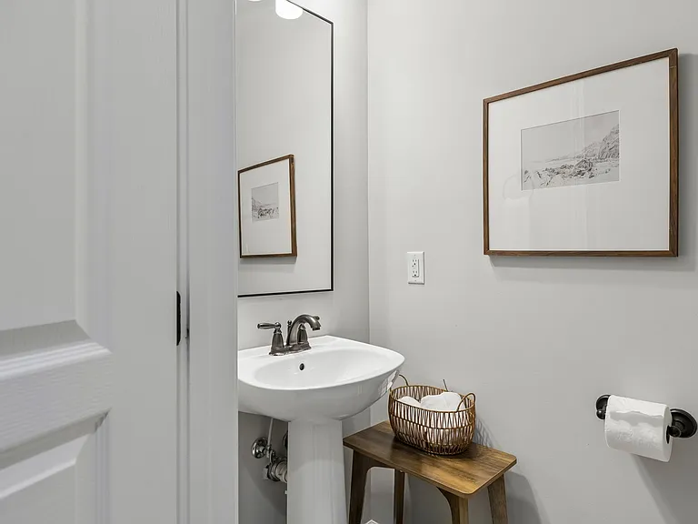 Located on the main level, the elegant powder room is conveniently located.