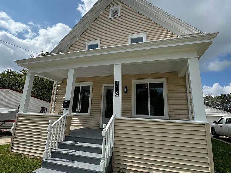 Covered Front Porch with 1.5 Car Garage and off-street parking