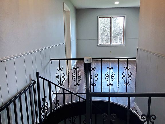 Staircase with gate to basement