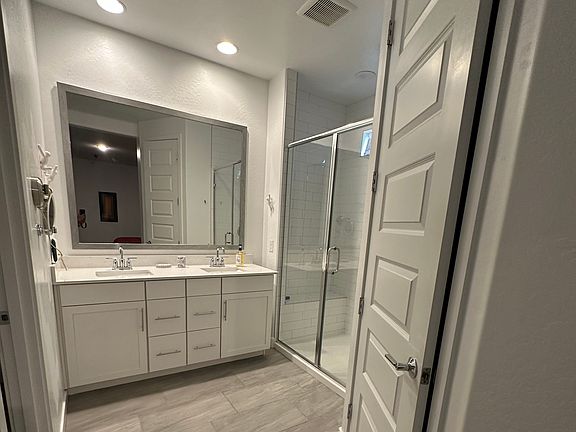 Main bath with large shower and two sinks