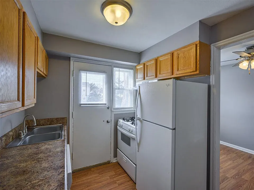 Kitchen with white appliances in a unit at Colonial Park.