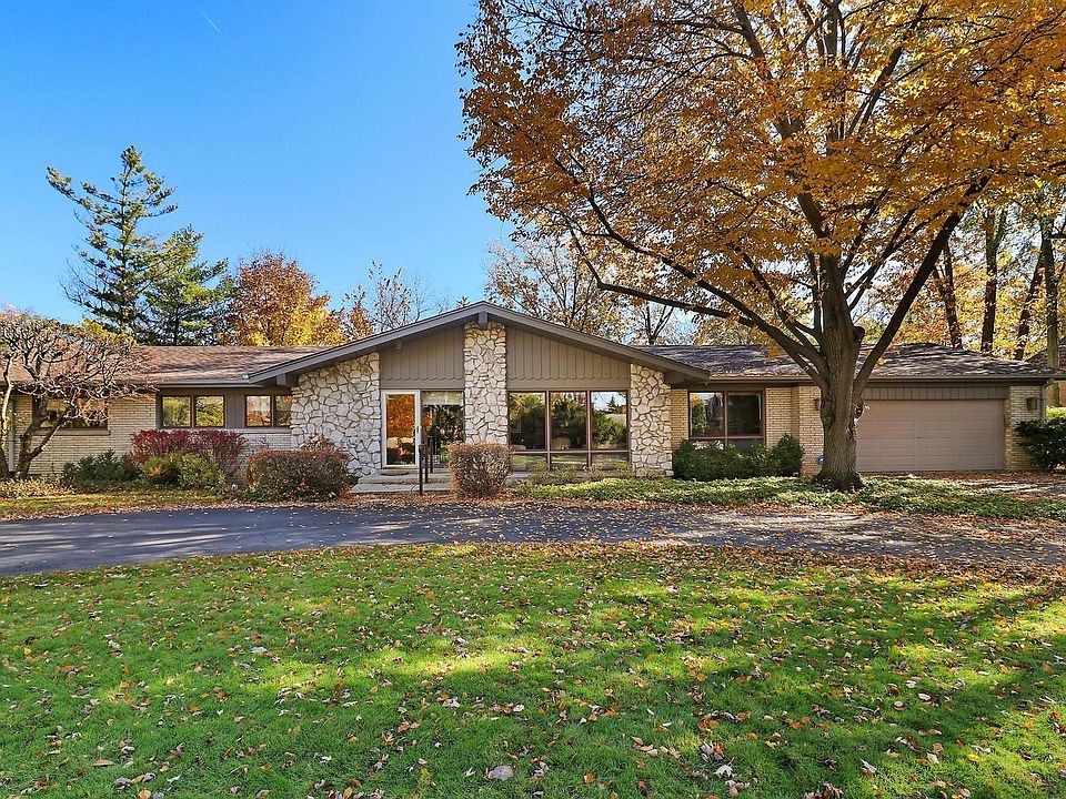Classic brick & stone ranch with a circular drive
