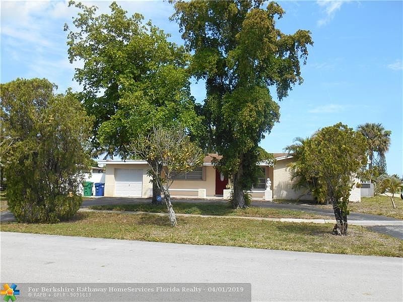 FRONT OF PROPERTY SHOWING WIDE CORNER  LOT, CIRCULAR DRIVEWAY AND GARAGE