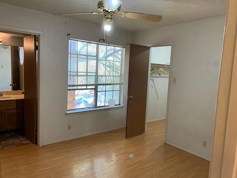 Bedroom Two with private full bath, walk in closet and laminate wood flooring.