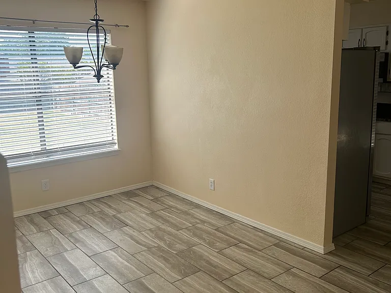 Dining area connected to living room and kitchen