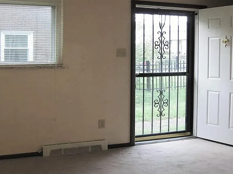 Front door entrance into bright sunny living room