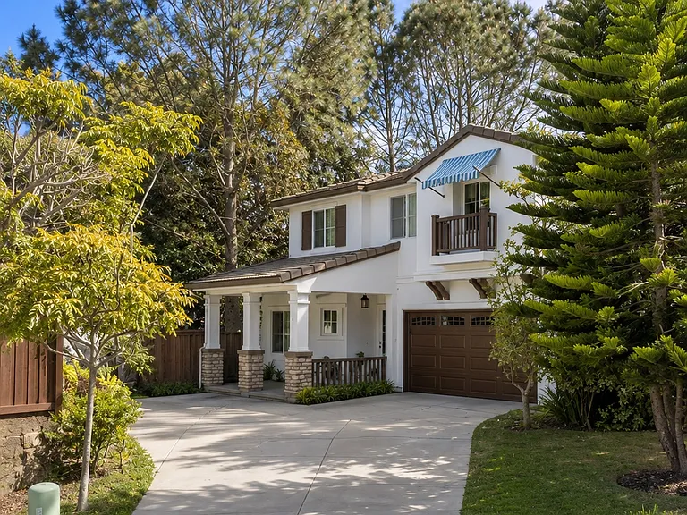 Home surrounded by trees. Driveway provides plenty of off-street parking.