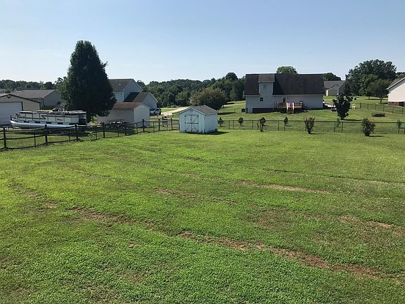 Fenced in backyard with shed
