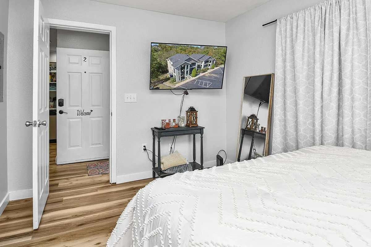 bedroom with mounted tv - 400 E Rockford Dr #102