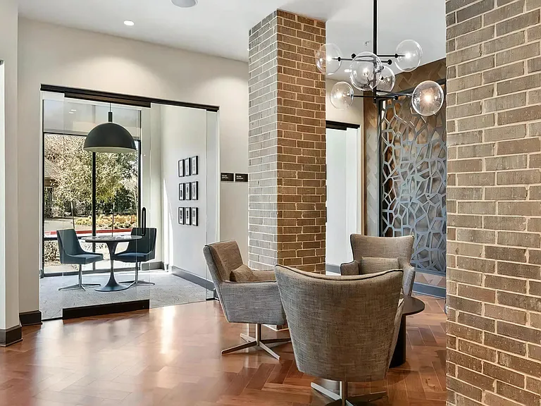 Contemporary Leasing Office with Brick Columns and Artful Touches