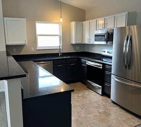 Beautiful updated kitchen with painted cabinetry and stainless steel appliances.