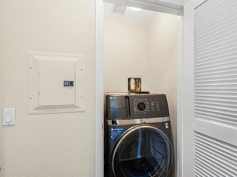 Washer/Dryer Combo inside Laundry Cabinet within unit