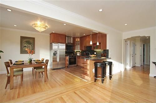 Another view of kitchen and dining with beautiful hardwood floors